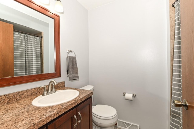 bathroom featuring toilet, visible vents, and vanity