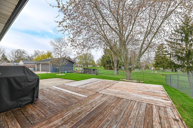 wooden terrace featuring a yard, a grill, and fence