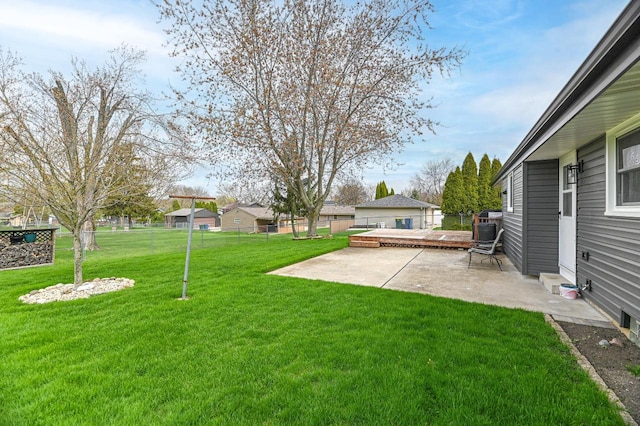 view of yard with a patio area, fence, and a deck