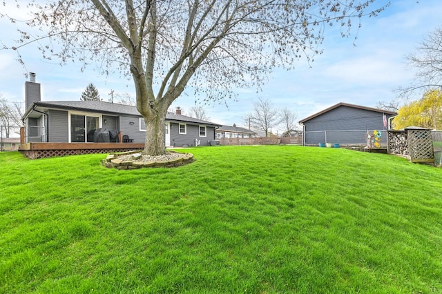 view of yard with fence and a deck