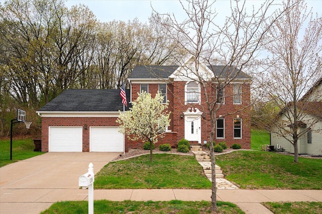 1218 Red Cedar Ct, Onalaska, WI 54650 - colonial home with a garage, brick siding, driveway, and a front yard