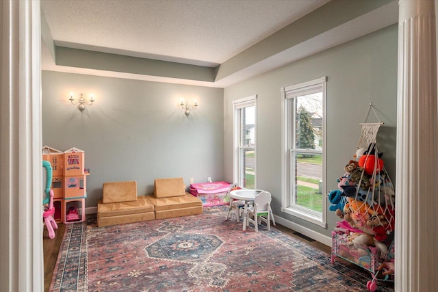 1218 Red Cedar Ct, Onalaska, WI 54650 - playroom featuring plenty of natural light, visible vents, baseboards, and wood finished floors