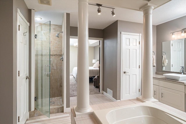 1218 Red Cedar Ct, Onalaska, WI 54650 - full bathroom featuring visible vents, a stall shower, and ornate columns