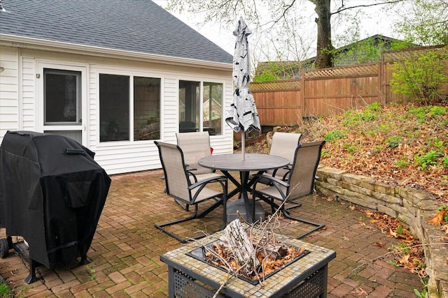 1218 Red Cedar Ct, Onalaska, WI 54650 - view of patio featuring area for grilling, outdoor dining space, fence, and a fire pit
