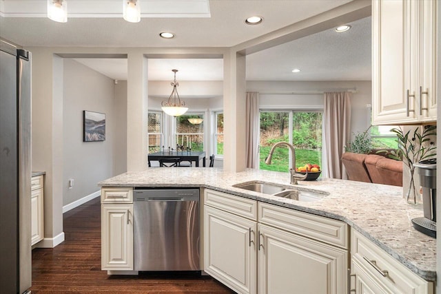 1218 Red Cedar Ct, Onalaska, WI 54650 - kitchen with a sink, stainless steel appliances, light stone counters, recessed lighting, and dark wood finished floors