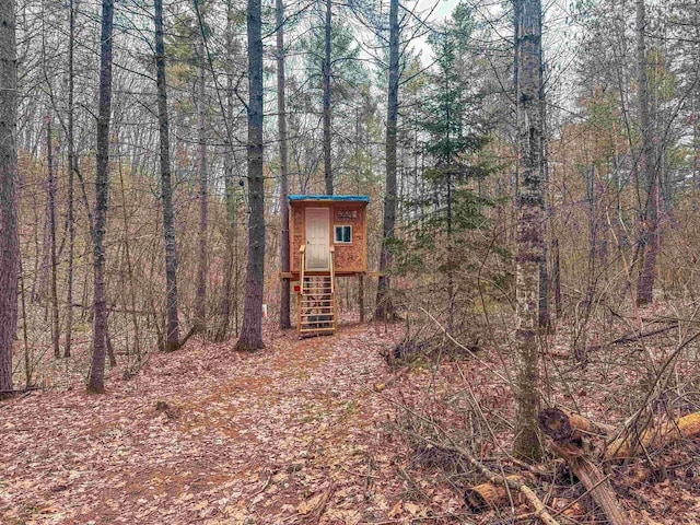 7589 Nose Lake Rd, Rhinelander, WI 54501 - view of outdoor structure with a wooded view