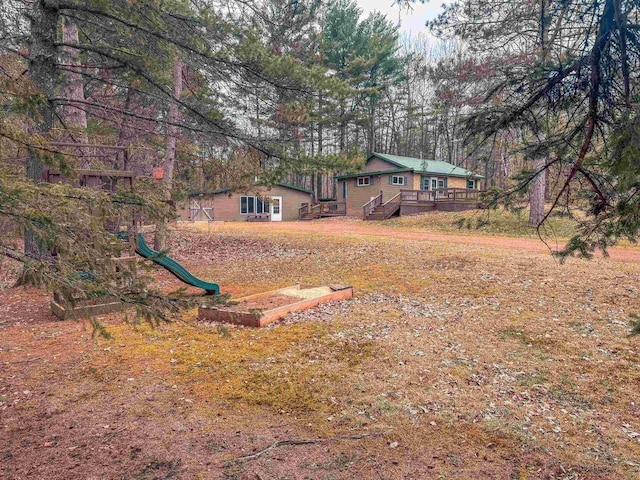 7589 Nose Lake Rd, Rhinelander, WI 54501 - view of yard with a wooden deck and a playground