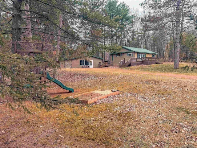7589 Nose Lake Rd, Rhinelander, WI 54501 - view of yard with a playground and a wooden deck