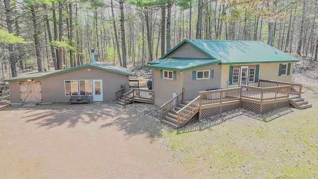 7589 Nose Lake Rd, Rhinelander, WI 54501 - rear view of property with metal roof, a deck, and a forest view