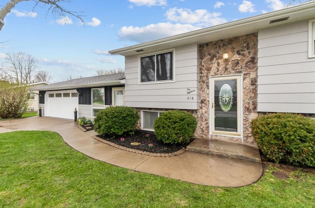 view of front facade featuring concrete driveway, a garage, stone siding, and a front lawn