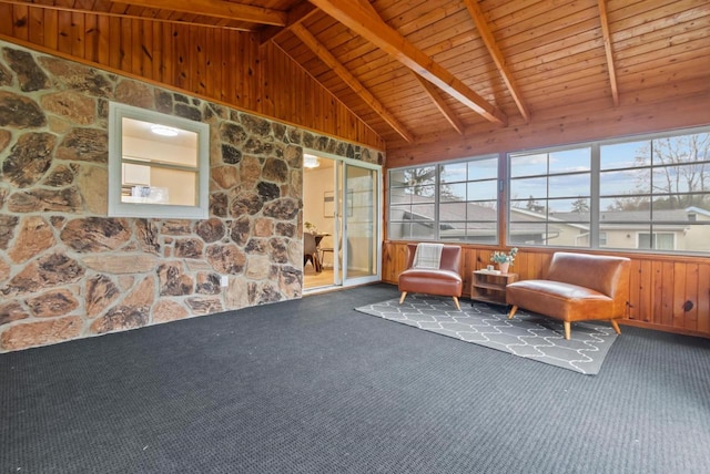 sunroom / solarium with carpet flooring, wooden walls, wood ceiling, and lofted ceiling with beams