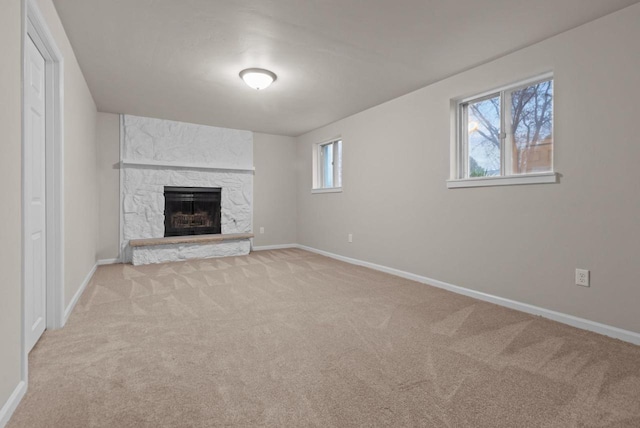 unfurnished living room featuring light colored carpet and baseboards