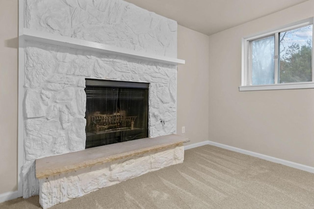 details featuring a fireplace, carpet floors, and baseboards