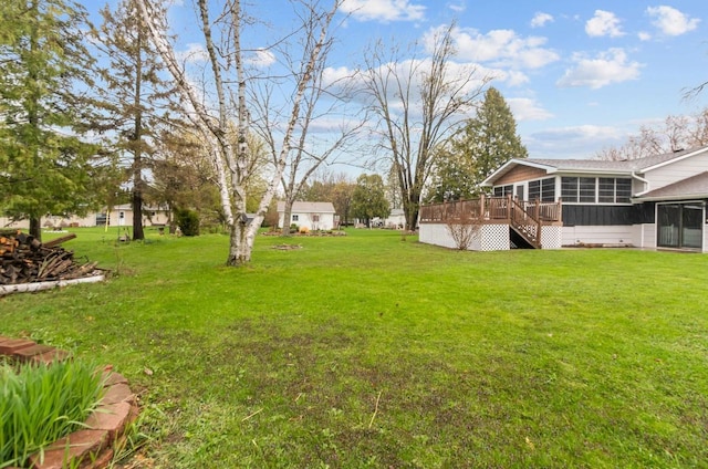 view of yard with a sunroom, stairway, and a deck
