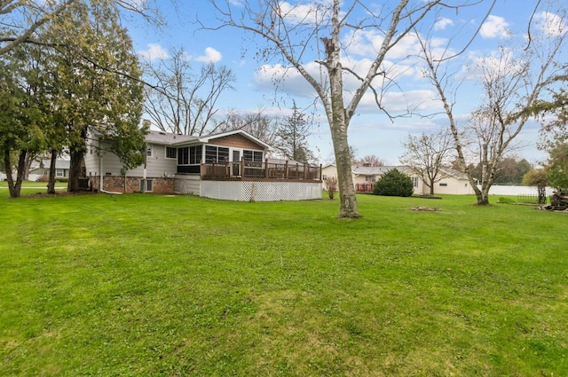 view of yard with a wooden deck and a sunroom