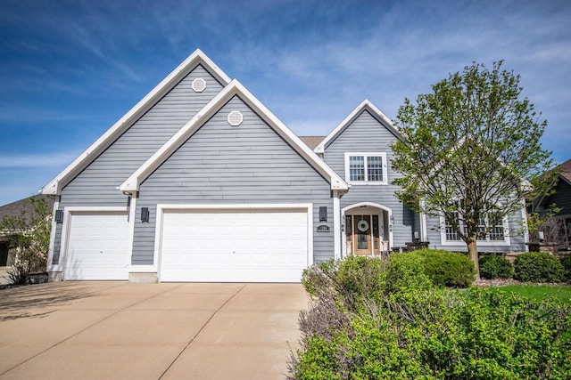 2704 Kettle Ct, West Bend, WI 53090 - view of front of house featuring an attached garage and driveway