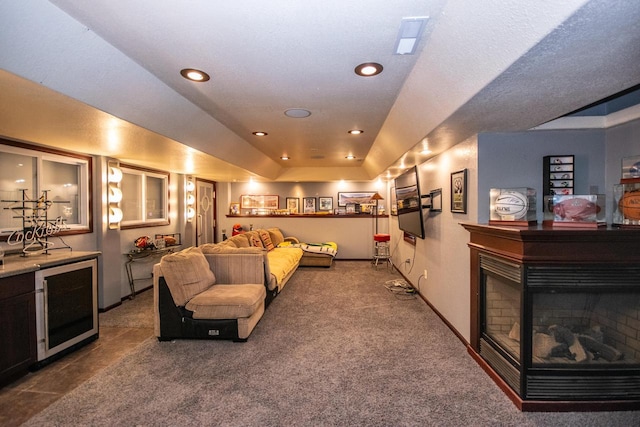 2704 Kettle Ct, West Bend, WI 53090 - carpeted living area featuring a tray ceiling, a multi sided fireplace, baseboards, and recessed lighting