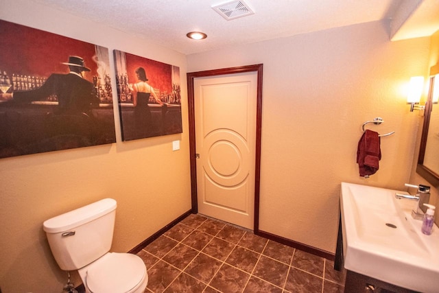 2704 Kettle Ct, West Bend, WI 53090 - bathroom with toilet, vanity, visible vents, tile patterned floors, and baseboards