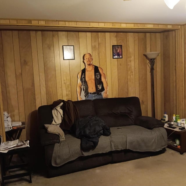carpeted living room featuring wood walls