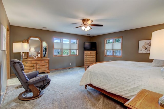 bedroom with carpet flooring, baseboards, and a ceiling fan