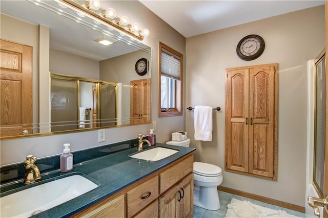 full bathroom with a sink, double vanity, toilet, and a shower stall