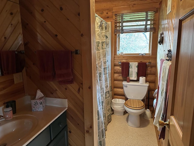bathroom featuring toilet, rustic walls, vanity, and a shower with curtain