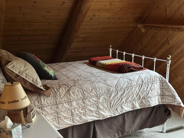 bedroom with wood ceiling and wooden walls