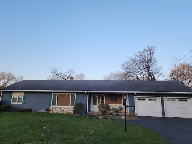 single story home with a front yard, driveway, a chimney, and a garage