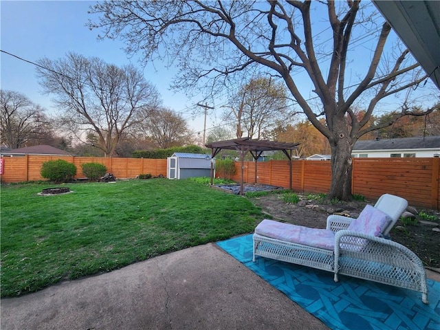 view of yard with a storage unit, a pergola, an outdoor structure, a fenced backyard, and a patio area