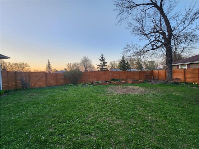 view of yard with a vegetable garden and a fenced backyard