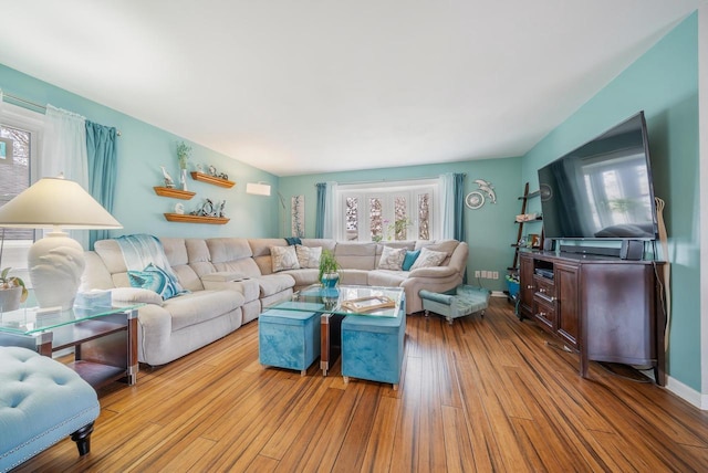 living room with plenty of natural light and wood finished floors
