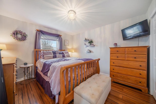 bedroom featuring baseboards and wood-type flooring