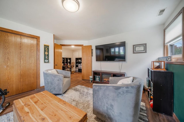living room with visible vents and wood finished floors