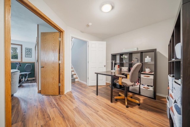 home office with baseboards and wood finished floors