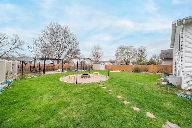 view of yard featuring an outdoor fire pit, a pergola, and a fenced backyard