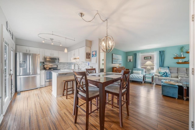 dining room with a notable chandelier and light wood finished floors