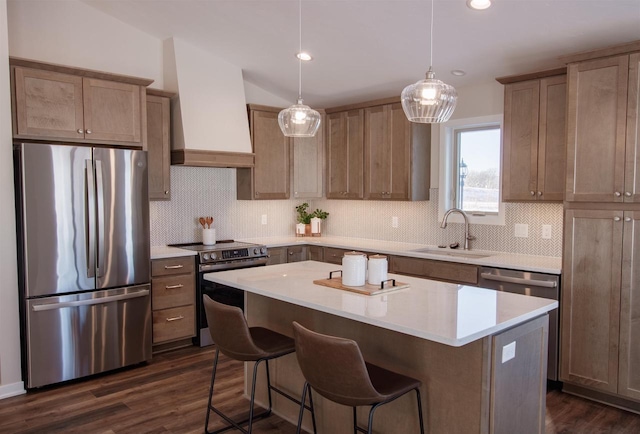 kitchen with a sink, decorative backsplash, a center island, custom range hood, and appliances with stainless steel finishes