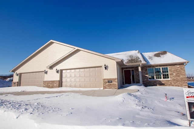 ranch-style home featuring brick siding and an attached garage