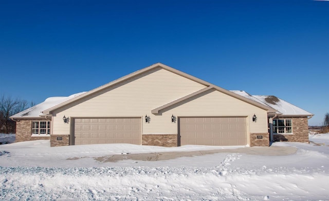 ranch-style home featuring an attached garage and brick siding