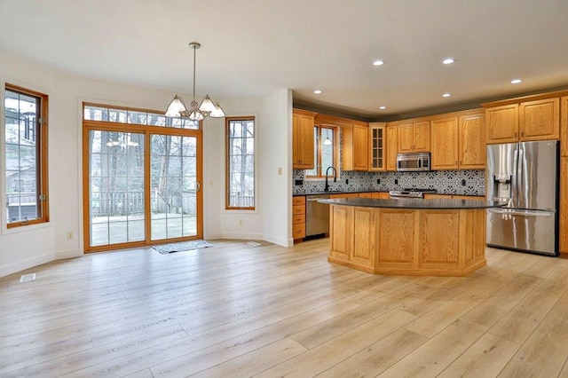 4109 Oak Ter, Weston, WI 54476 - kitchen with baseboards, dark countertops, stainless steel appliances, and a chandelier