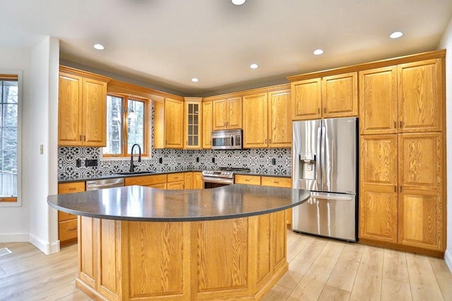 4109 Oak Ter, Weston, WI 54476 - kitchen with a sink, light wood finished floors, stainless steel appliances, and dark countertops