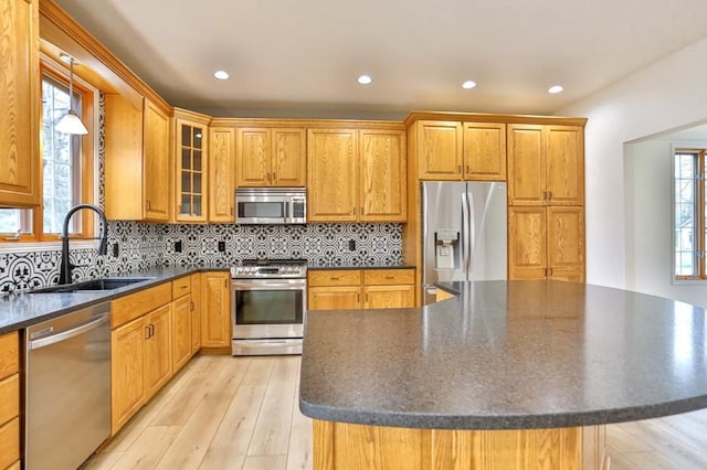 4109 Oak Ter, Weston, WI 54476 - kitchen featuring glass insert cabinets, a center island, a sink, dark countertops, and stainless steel appliances