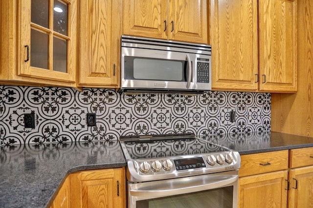 4109 Oak Ter, Weston, WI 54476 - kitchen featuring glass insert cabinets, brown cabinetry, dark stone countertops, tasteful backsplash, and appliances with stainless steel finishes