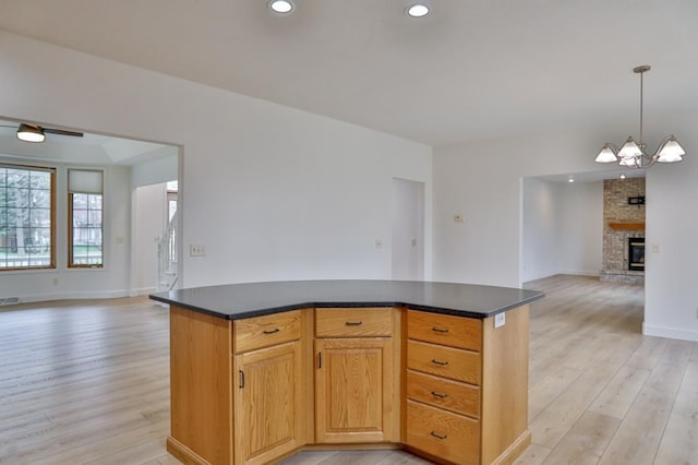 4109 Oak Ter, Weston, WI 54476 - kitchen featuring dark countertops, light wood-type flooring, a chandelier, and open floor plan
