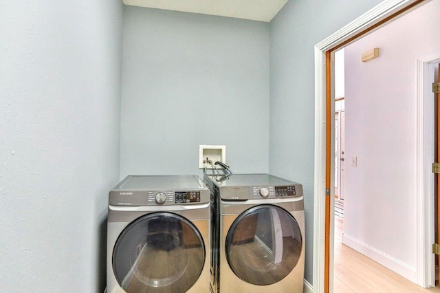4109 Oak Ter, Weston, WI 54476 - laundry room with light wood finished floors, washing machine and dryer, baseboards, and laundry area
