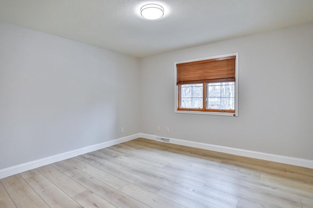 4109 Oak Ter, Weston, WI 54476 - empty room with baseboards, visible vents, a textured ceiling, and wood finished floors