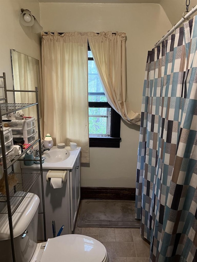 full bath featuring curtained shower, tile patterned flooring, toilet, and vanity