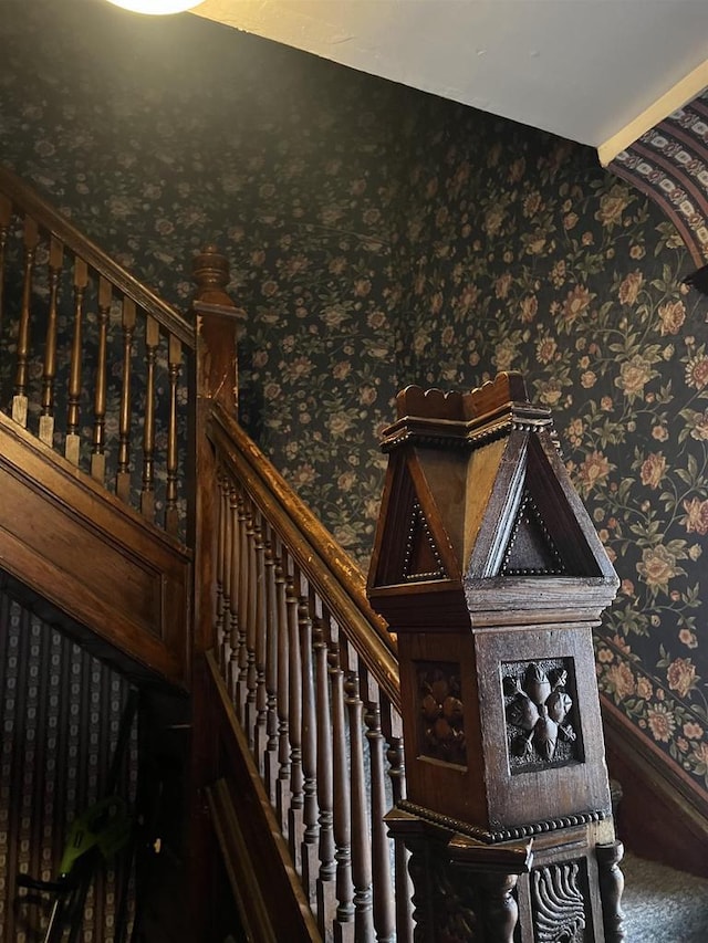 stairs with wallpapered walls