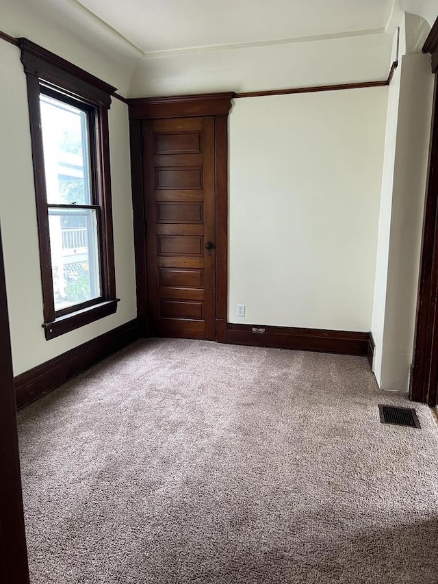 carpeted spare room with baseboards and visible vents