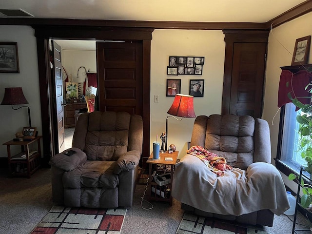 living area featuring carpet floors and visible vents